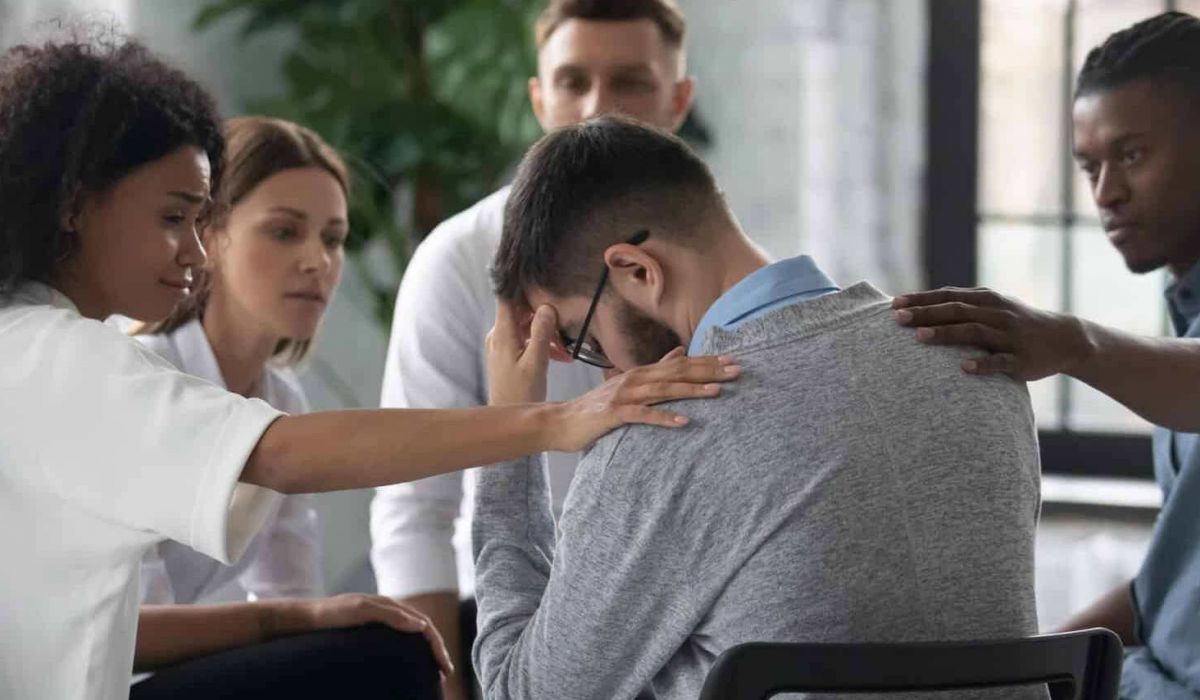 A man wearing glasses holds his head and screams in frustration, symbolizing emotional distress and the need for mental health or addiction support.