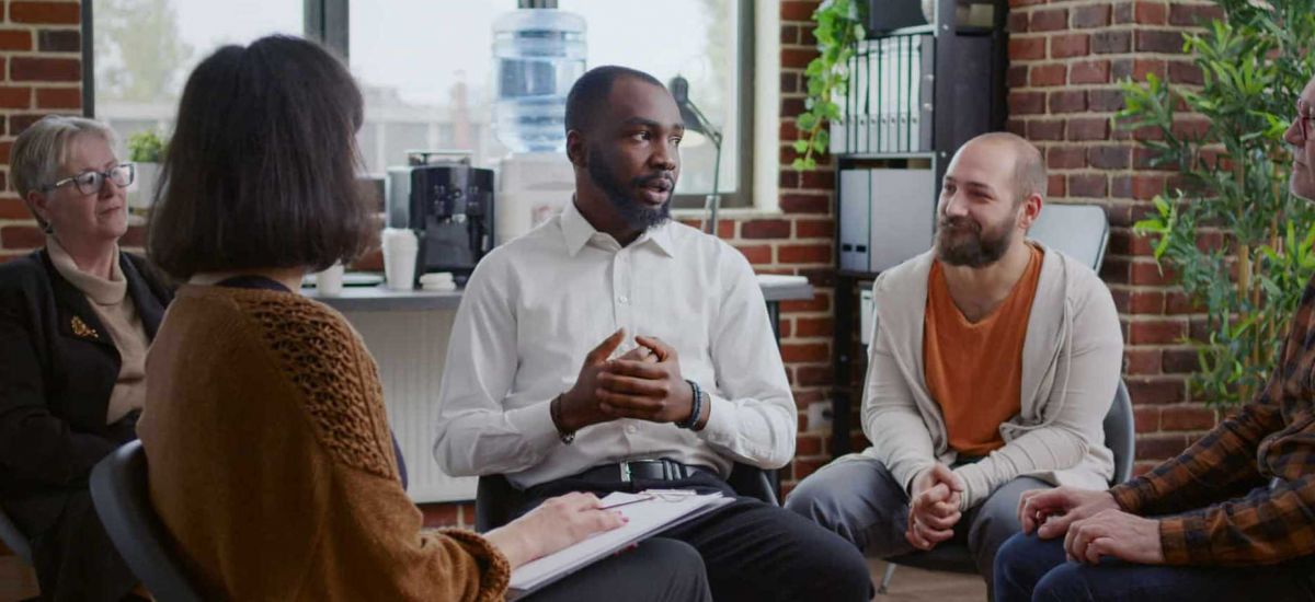 people sitting in a circle during group therapy