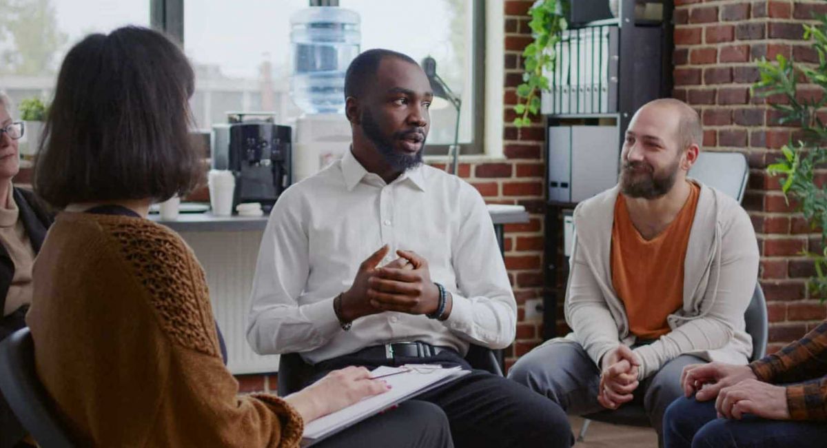 people sitting in a circle during group therapy