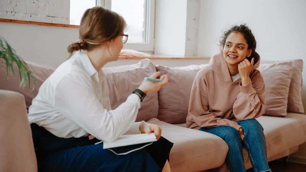 Female patient talking with her therapist about the benefits of rehab and contemplating the question, Do I need rehab?