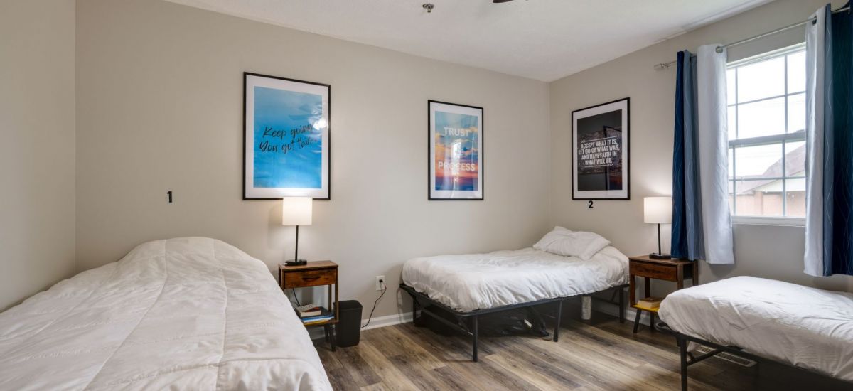 a bedroom with 2 twin beds that looks cozy and inviting at an inpatient center for addiction