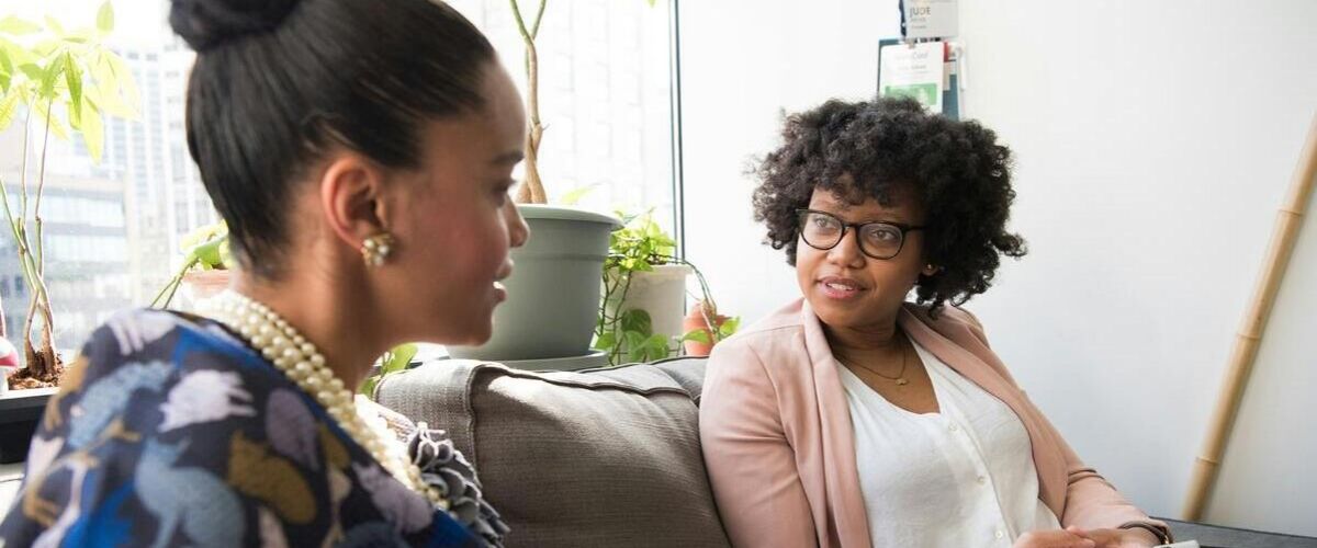 A woman sits next to her therapy as she discusses the struggles of substance abuse