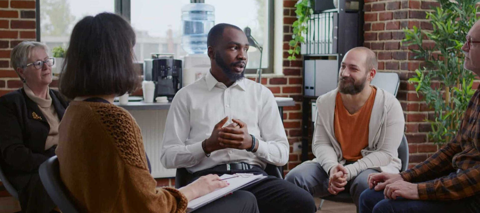 people sitting in a circle during group therapy